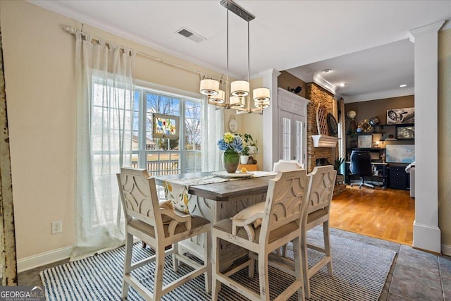 dining room with crown molding, visible vents, an inviting chandelier, wood finished floors, and baseboards