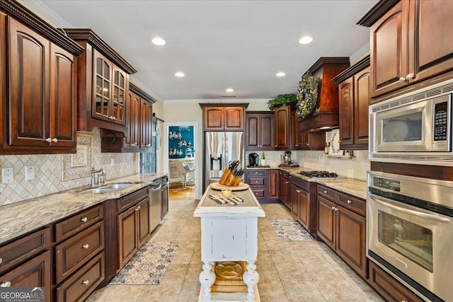 kitchen with a sink, appliances with stainless steel finishes, backsplash, glass insert cabinets, and custom range hood