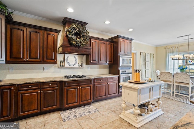 kitchen with dark brown cabinetry, ornamental molding, appliances with stainless steel finishes, light stone countertops, and custom range hood