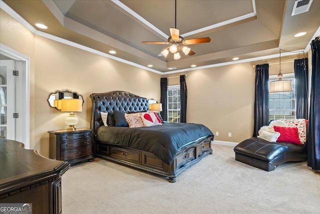 carpeted bedroom with a tray ceiling, recessed lighting, visible vents, ornamental molding, and baseboards