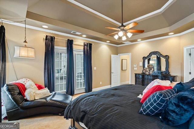 bedroom featuring carpet floors, a tray ceiling, crown molding, visible vents, and baseboards