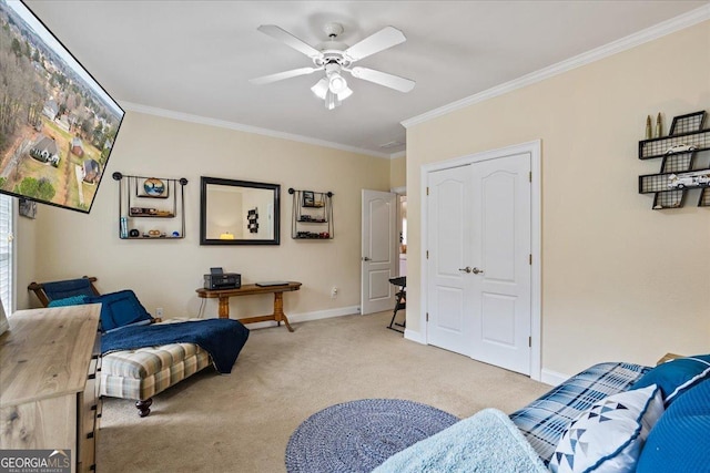 sitting room featuring carpet floors, a ceiling fan, baseboards, and crown molding