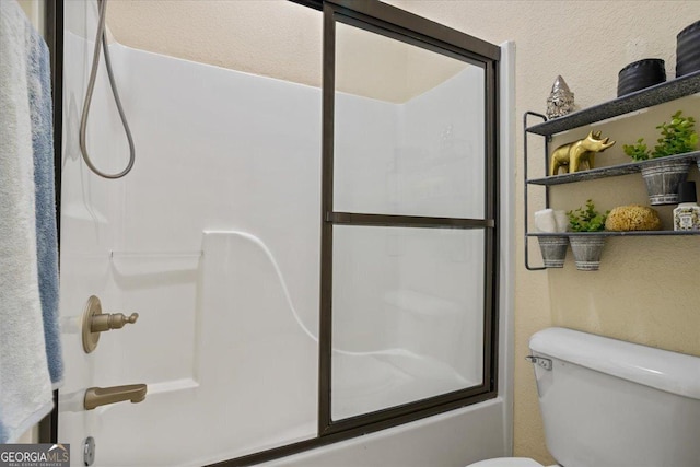 full bath with toilet and combined bath / shower with glass door