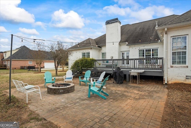 view of patio featuring a deck and an outdoor fire pit