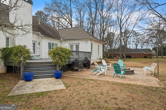 view of yard featuring a fire pit, a deck, and a patio area