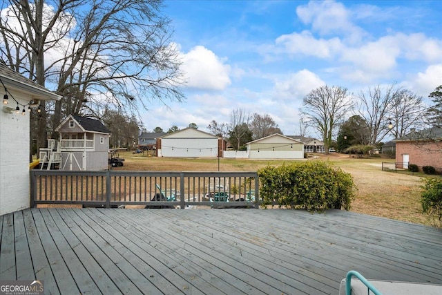 wooden deck featuring a lawn