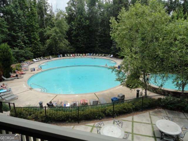 pool featuring fence and a patio