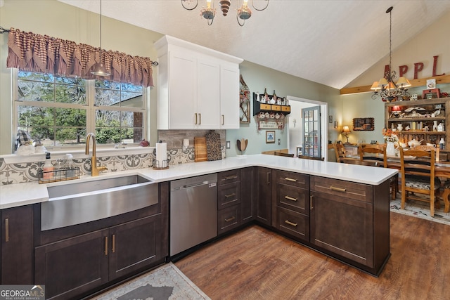 kitchen featuring light countertops, a notable chandelier, a sink, and stainless steel dishwasher