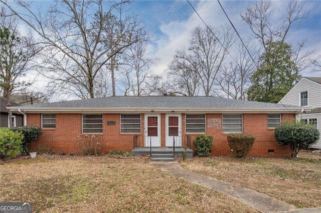 single story home with a shingled roof, crawl space, brick siding, and a front lawn