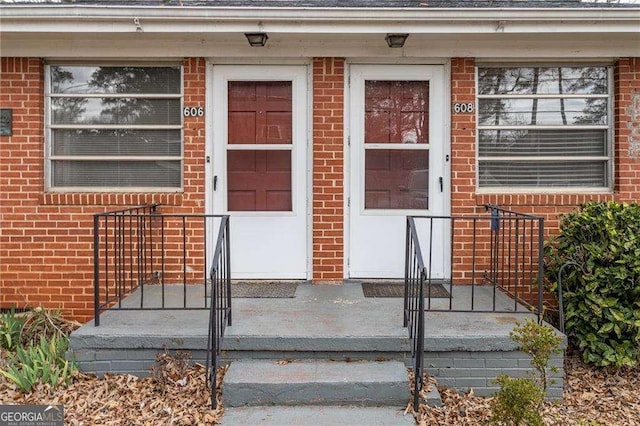 property entrance with brick siding