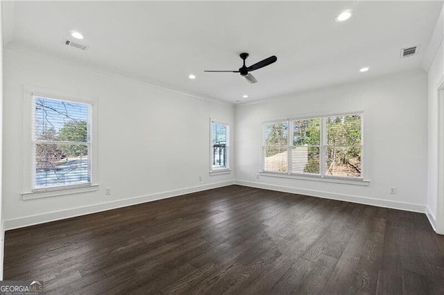 unfurnished room with visible vents, recessed lighting, crown molding, baseboards, and dark wood-style flooring