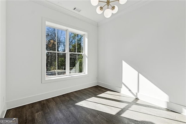 empty room featuring wood finished floors, baseboards, visible vents, an inviting chandelier, and crown molding