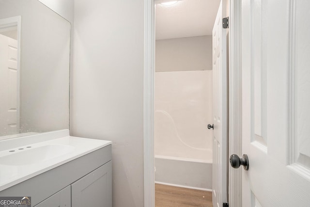 bathroom with wood finished floors and vanity