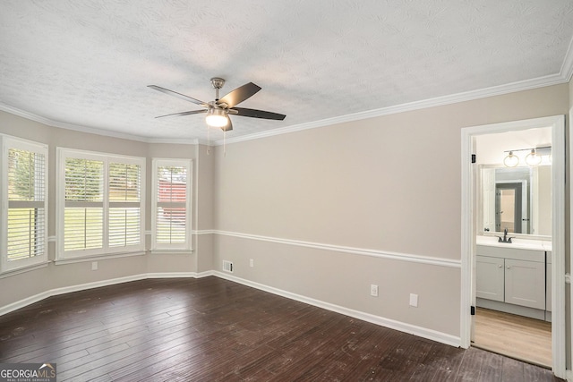 unfurnished room featuring a textured ceiling, dark wood-type flooring, and a sink