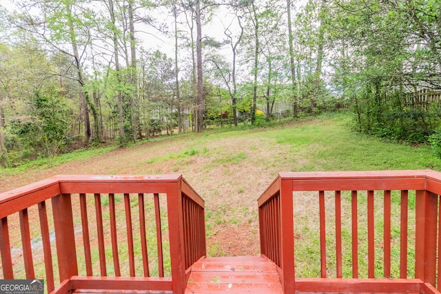 wooden deck with a lawn