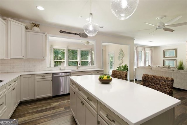 kitchen with stainless steel dishwasher, open floor plan, light countertops, decorative backsplash, and dark wood-style flooring