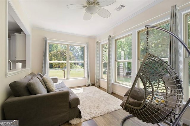 sunroom with visible vents and a ceiling fan