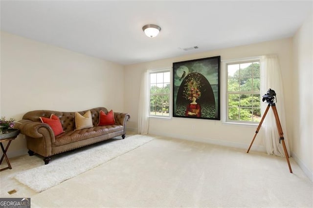 living area with carpet flooring and baseboards