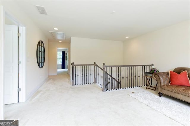 sitting room with visible vents, an upstairs landing, recessed lighting, carpet flooring, and attic access