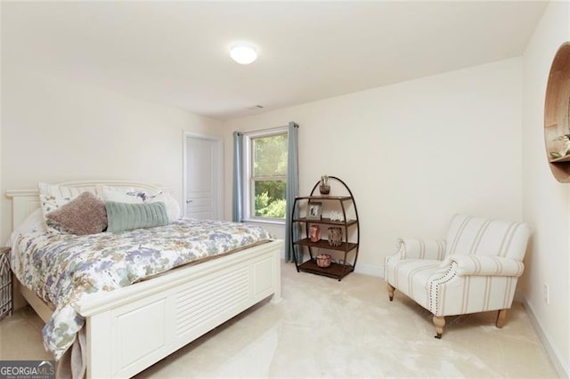 bedroom with baseboards and light colored carpet