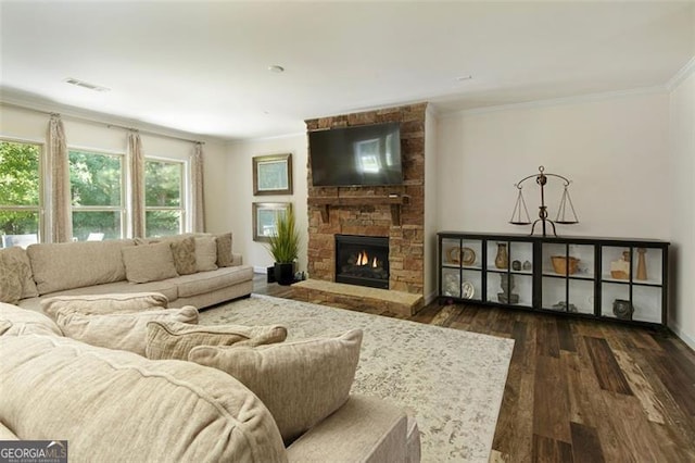 living area featuring a fireplace, wood finished floors, visible vents, and ornamental molding