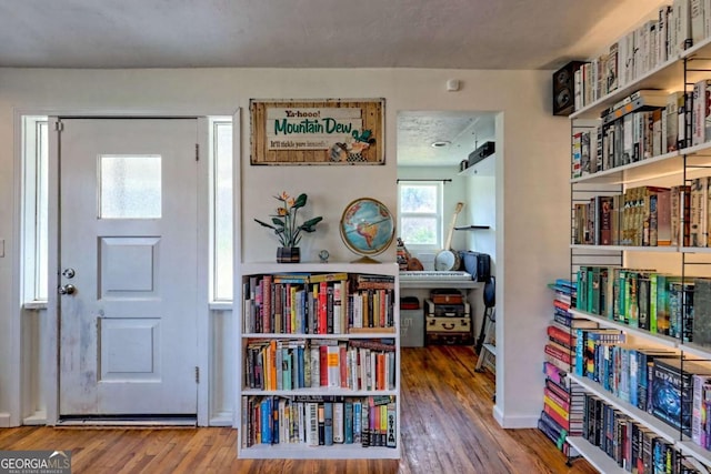 interior space featuring wood finished floors and baseboards