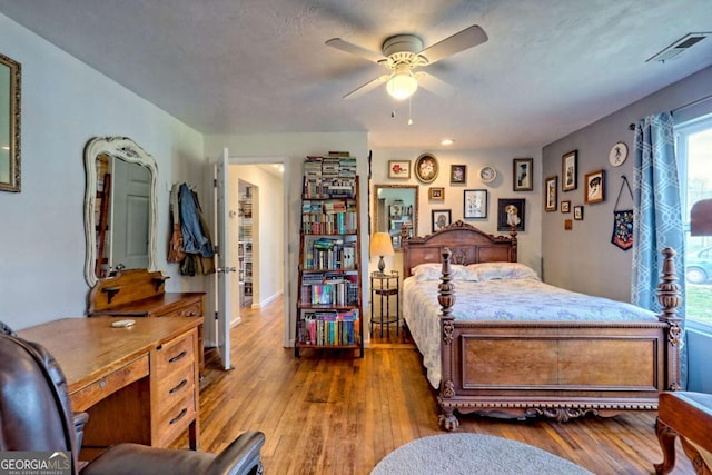 bedroom with visible vents and wood finished floors