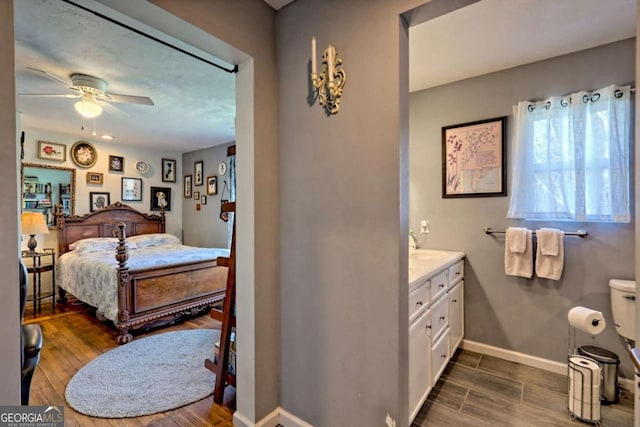 bedroom featuring dark wood finished floors and baseboards