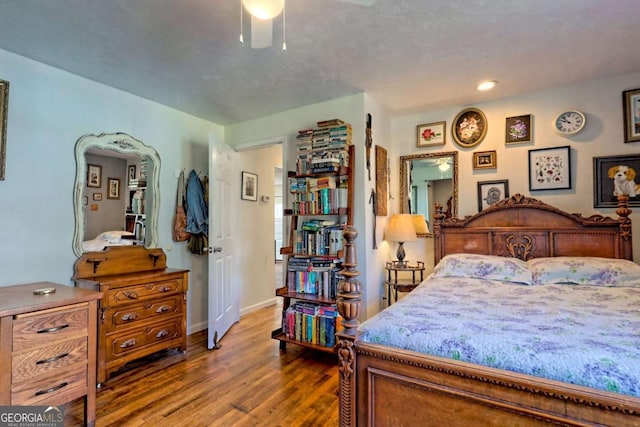 bedroom featuring recessed lighting, wood finished floors, and baseboards