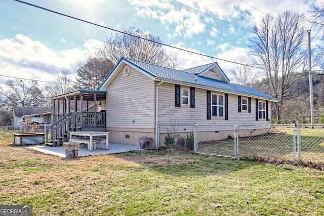 view of property exterior featuring metal roof, crawl space, fence, a yard, and a patio area