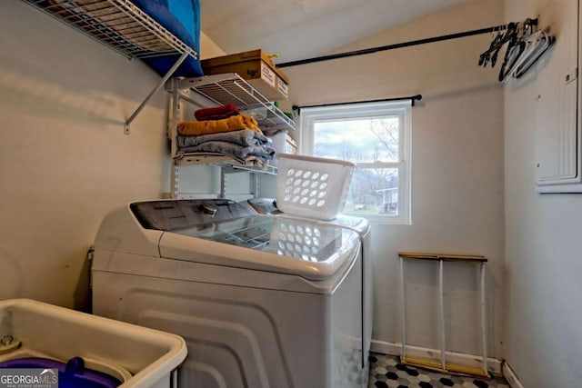 laundry area with laundry area, independent washer and dryer, and a sink