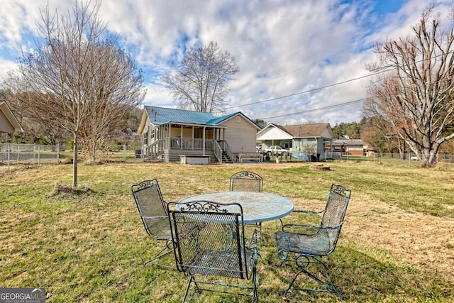 exterior space with outdoor dining area and fence