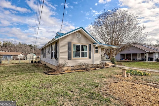 view of front of property with crawl space, fence, and a front yard