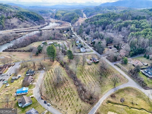 birds eye view of property with a view of trees