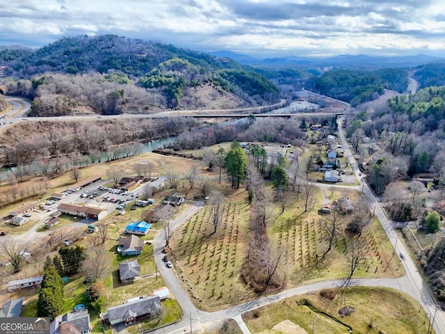 birds eye view of property with a wooded view