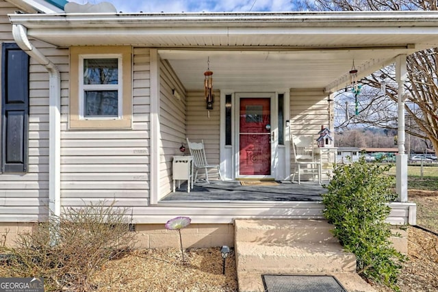 view of exterior entry featuring covered porch