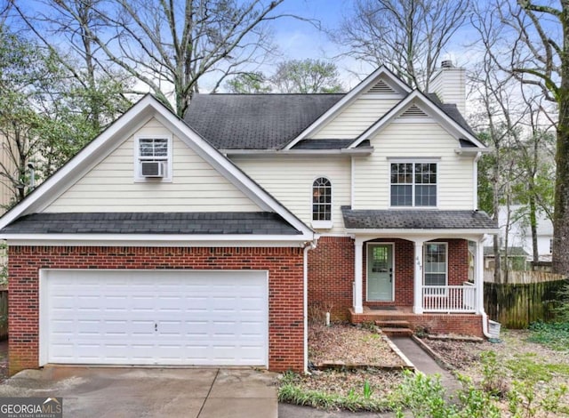 traditional-style house featuring driveway, a chimney, an attached garage, a porch, and brick siding