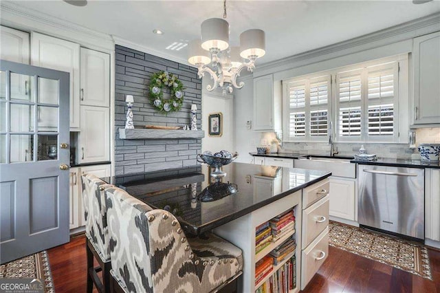 kitchen with dark countertops, ornamental molding, dark wood-type flooring, a sink, and dishwasher