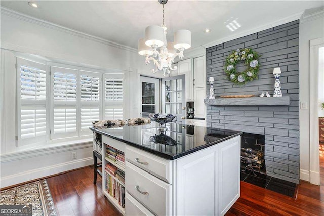 kitchen featuring white cabinets, dark wood finished floors, ornamental molding, pendant lighting, and open shelves