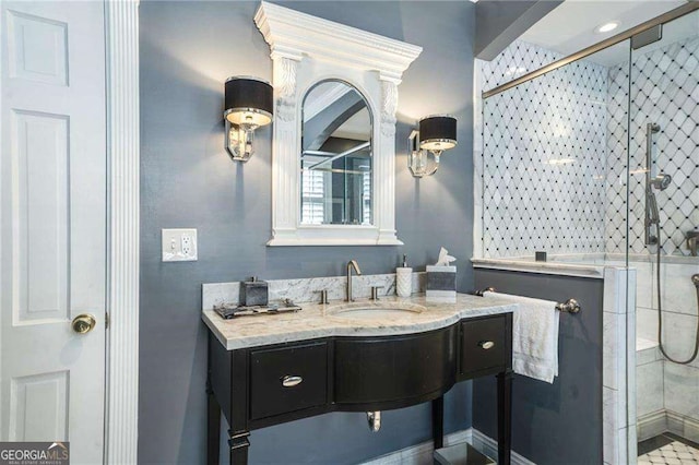 bathroom with a stall shower and vanity