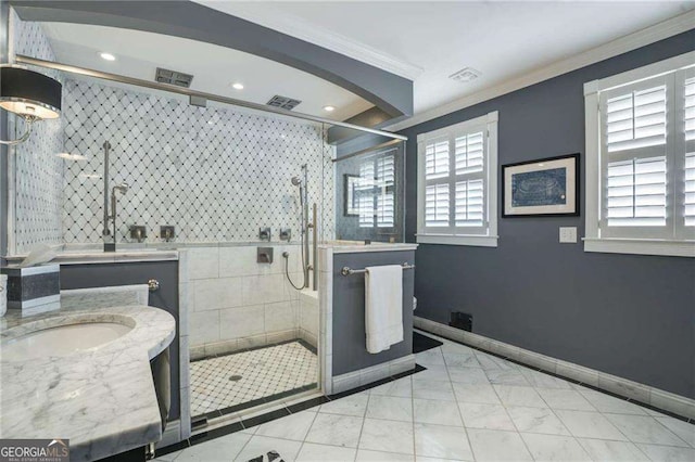 full bathroom featuring baseboards, visible vents, crown molding, and vanity