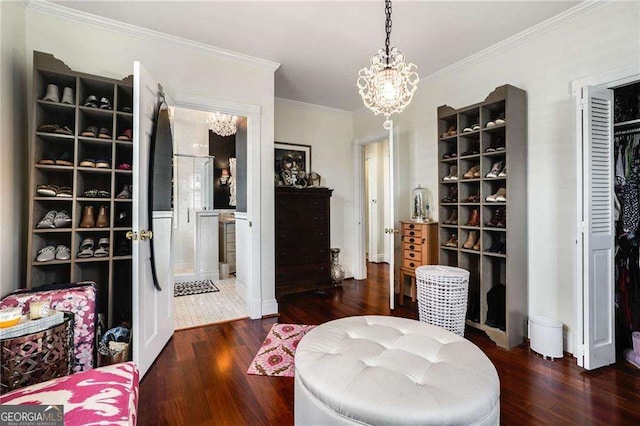 interior space featuring crown molding, a notable chandelier, and wood finished floors