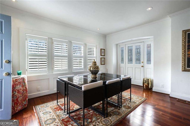 dining area with ornamental molding, visible vents, and wood finished floors