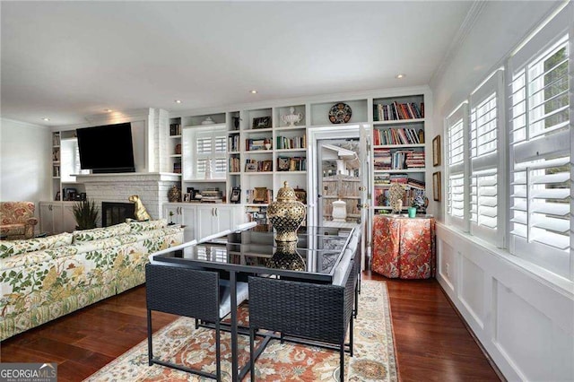 dining room featuring recessed lighting, a fireplace, wood finished floors, and crown molding