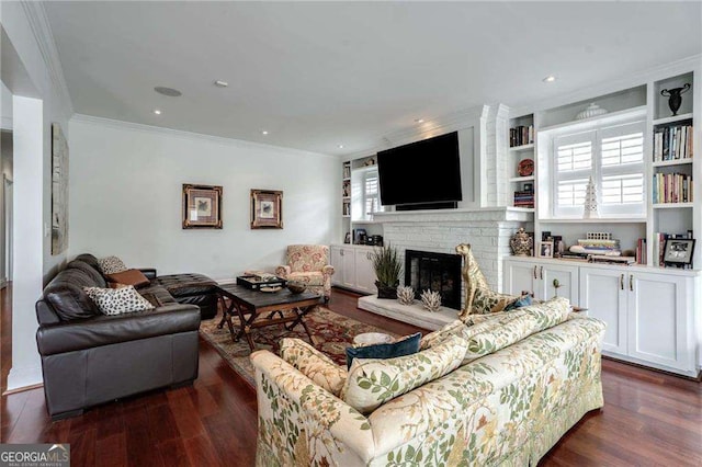 living area featuring a brick fireplace, ornamental molding, dark wood-type flooring, and recessed lighting