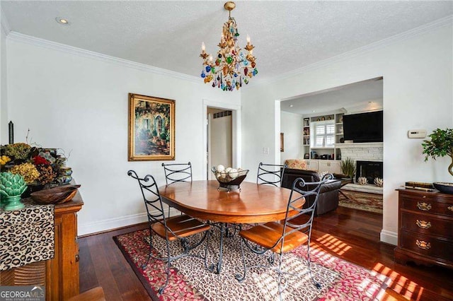 dining area with ornamental molding, baseboards, a textured ceiling, and hardwood / wood-style floors