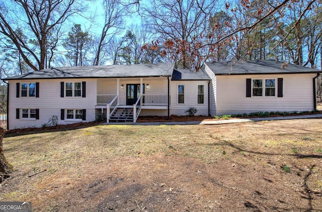 single story home with a front yard, covered porch, and brick siding