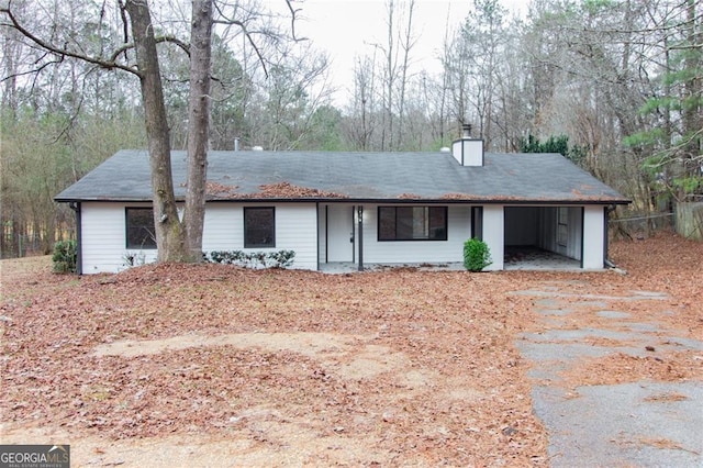 single story home with a chimney