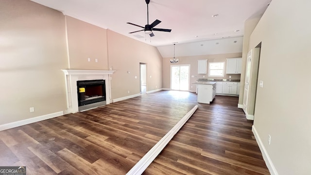 160 Coffey Rd Unit 18, Barnesville, GA 30204 - unfurnished living room with a ceiling fan, a fireplace, dark wood-style flooring, high vaulted ceiling, and a chandelier
