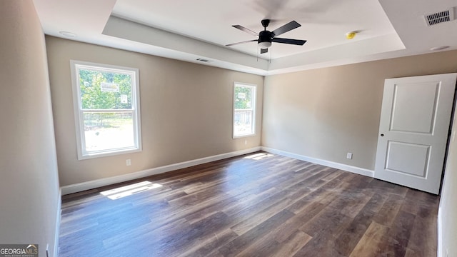 160 Coffey Rd Unit 18, Barnesville, GA 30204 - empty room with a raised ceiling, plenty of natural light, ceiling fan, and dark wood-style floors